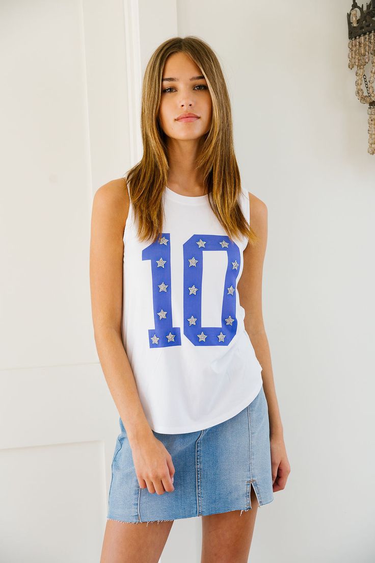 Have fun and stand out with CUSTOM NUMBER TOPS. Choose a white jersey, tee, or tank and personalize it with your own number and silver star patches. Show off your unique style on the field or off. (Winning attitude not included!) All orders are currently shipping within 14 business days. To receive item quicker, expedited shipping is available at checkout. Number Top, Star Patches, Small Tank, White Jersey, Jersey Tee, Silver Stars, The Field, Have Fun, Unique Style