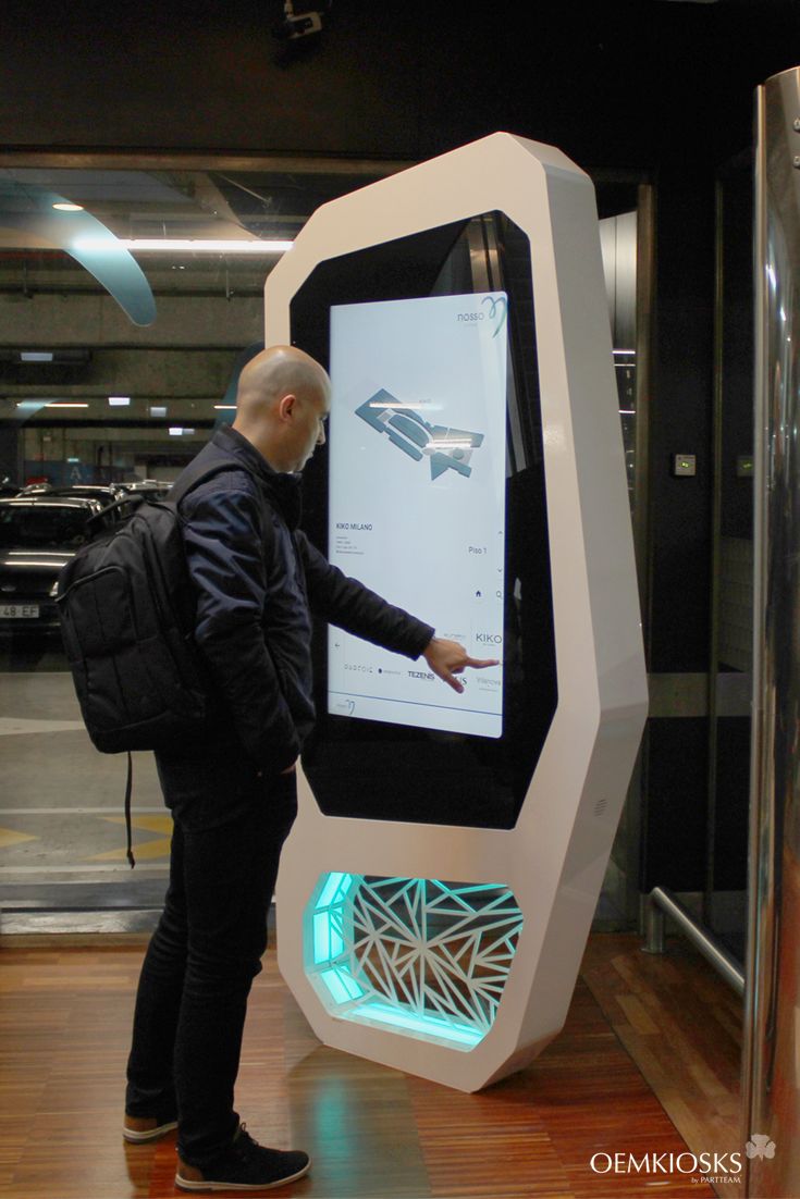 a man standing in front of a large display with an interactive screen on it's side