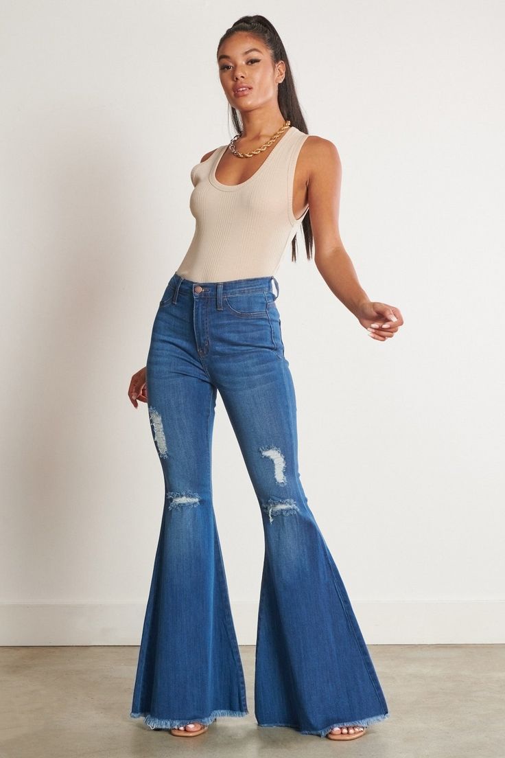 Don't just rock the concert scene - own it! These Lainey Concert Bell Bottom Jeans reign the fashion kingdom with iconic old school bell bottoms and just-right blue denim. Look cool and feel comfy in these edgy jeans made for concert outfits that stand out from the crowd. Ready to rock? Go for it! A pair of exaggerated, high-rise flare jeans featuring a front whiskered wash, open distressed knee detail, classic 5-pocket construction, frayed raw hem, and a zip-fly closure. (3) Rise: 11" Inseam: 3 Edgy Jeans, Distressed Flare Jeans, Bodycon Fashion, Premium Denim, Sheer Fabrics, Denim Fabric, Look Cool, Casual Wardrobe, Easy Wear