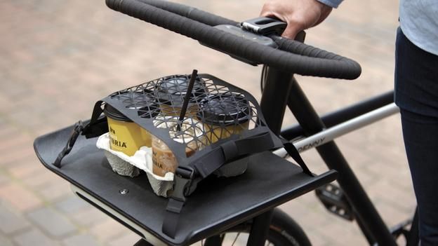 a close up of a person on a bike with food in the basket