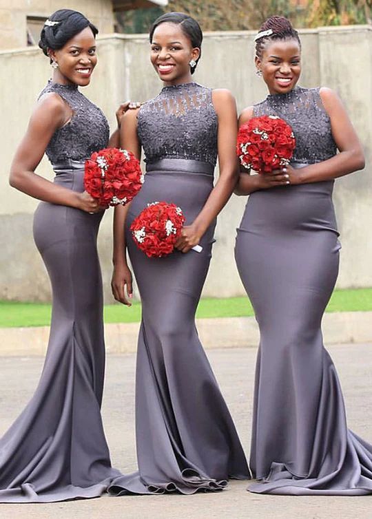 three women in grey dresses with red bouquets