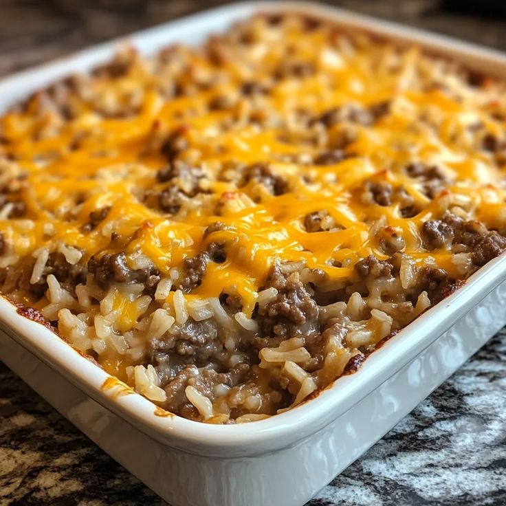 a casserole dish with cheese and ground beef