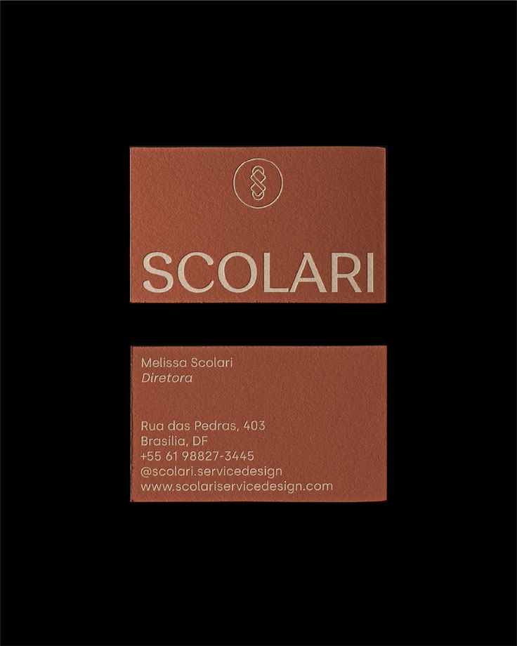 a business card with the word scolari on it in gold foil and black background