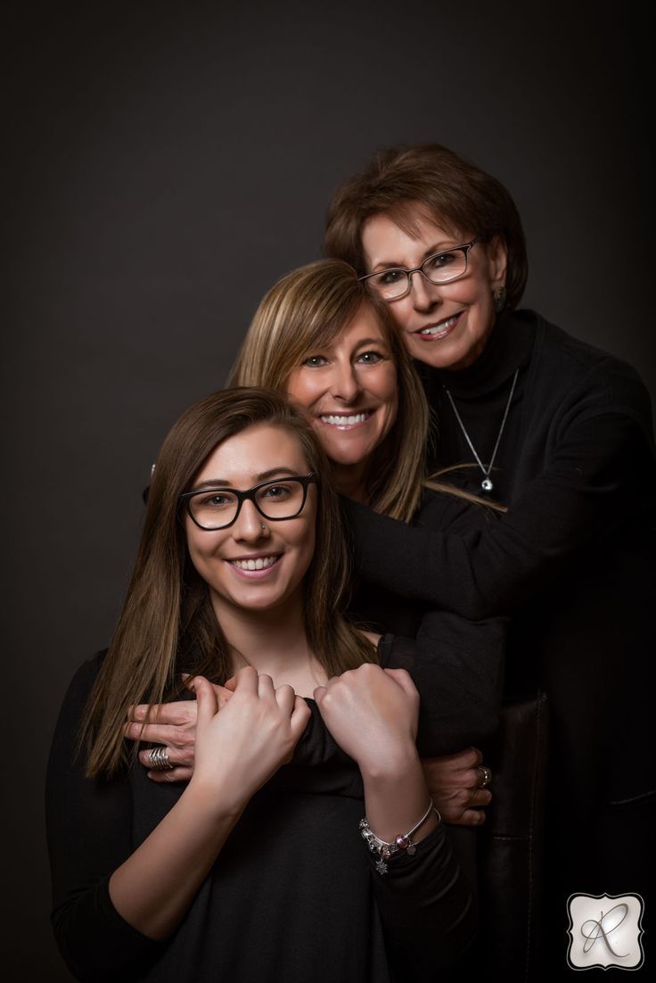 two women hugging and smiling for the camera with their arms around one woman's shoulders