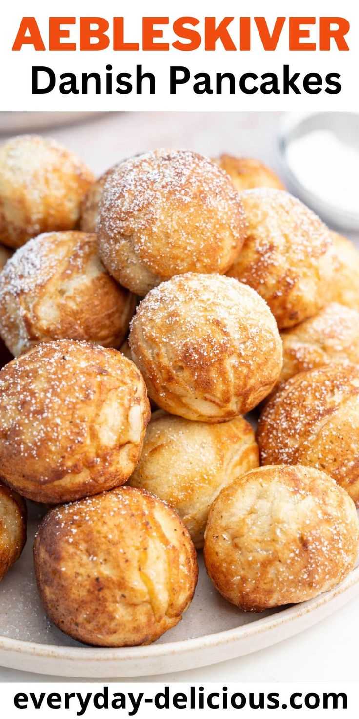 a plate full of danish pancakes with powdered sugar on top and text overlay