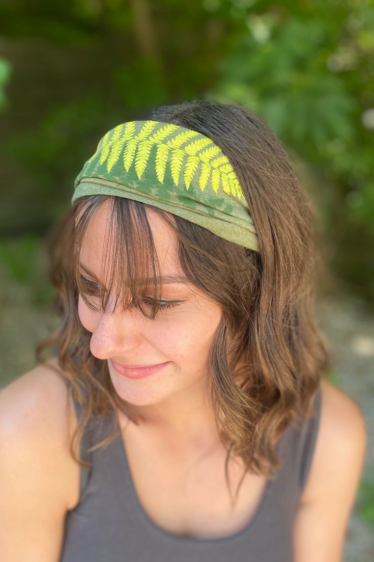 Pay homage to nature as you wear this Ferns Boho Headband. Featuring various shades of green and raw seams on an earth-friendly fabric. Displays a print of two beautiful fern plants. 9 inches wide by 8 inches tall (laying flat) - fabric can stretch from 18 to 26 inches in circumference. Eco Olive. Casual Green Headband, Adjustable Green Headband For Festivals, Adjustable Green Casual Headband, Adjustable Green Festival Headband, Green Bohemian Headband, Green Adjustable Headband For Summer, Adjustable Green Headband For Summer, Summer Green Adjustable Headband, Bohemian Green Headband For Spring