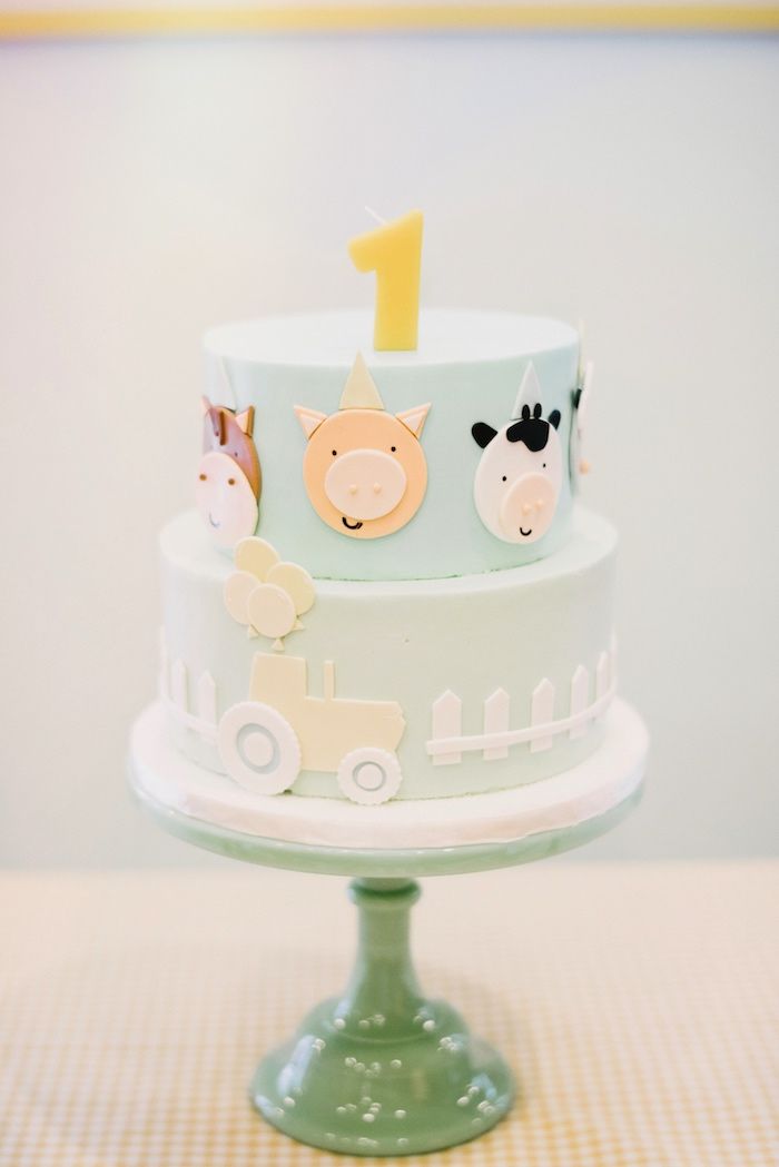 a three tiered cake with farm animals on it