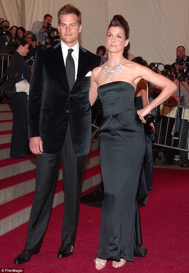 a man and woman standing next to each other on the red carpet at an event