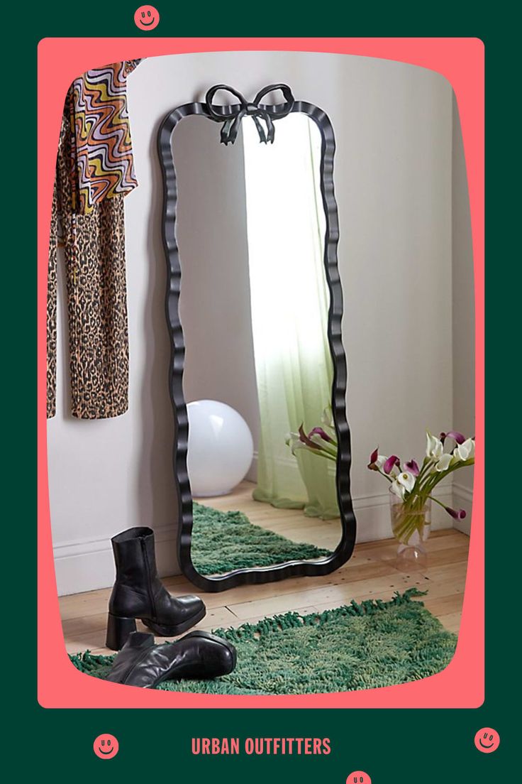 a pair of black boots sitting on top of a rug in front of a mirror