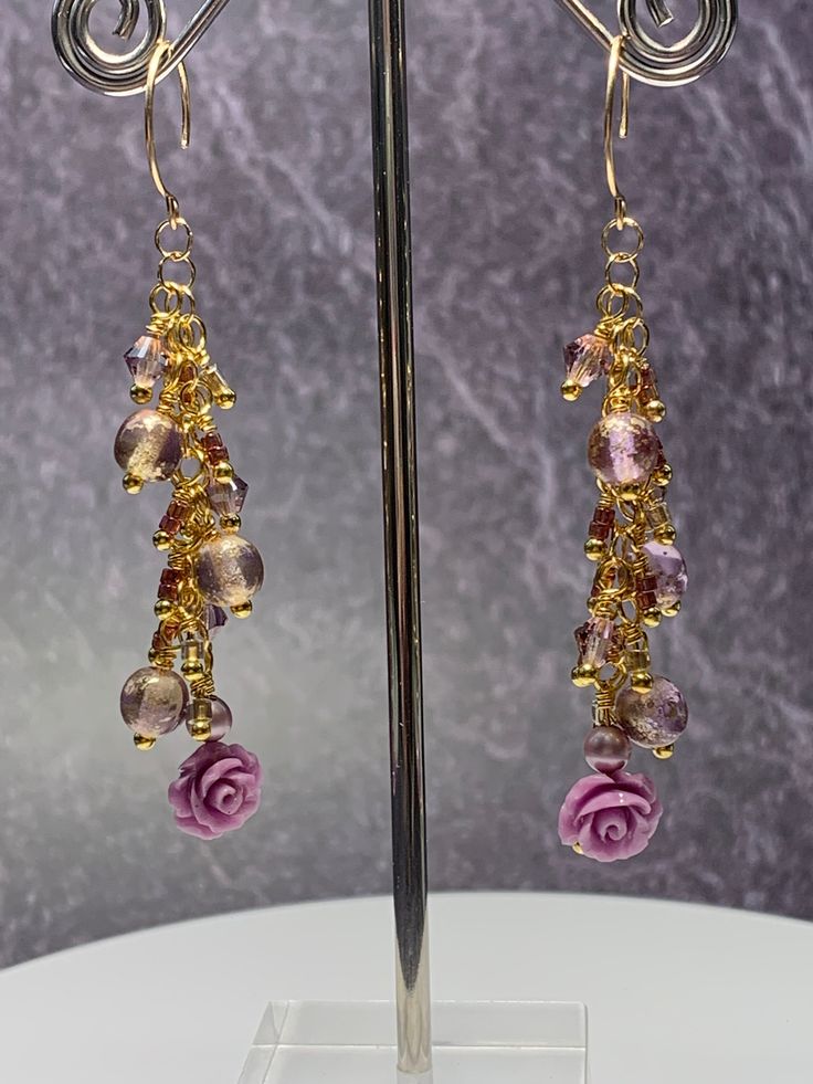 Beautiful acetate floral beads accented in lavender and gold Czech glass beads that measure approximately 2.25 inches in length. Ear wires are gold tone brass. Bohemian Lavender Beaded Dangle Earrings, Purple Czech Glass Beaded Earrings With Dangling Beads, Purple Czech Glass Earrings With Faceted Beads, Purple Czech Glass Earrings With Dangling Beads, Purple Chandelier, Purple Czech Glass Drop Earrings, Teardrop Beads, Beaded Dangle Earrings, Ear Wires