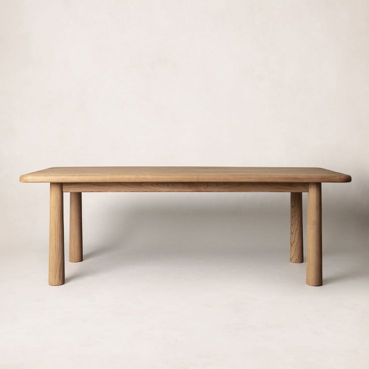 a wooden table sitting on top of a white floor