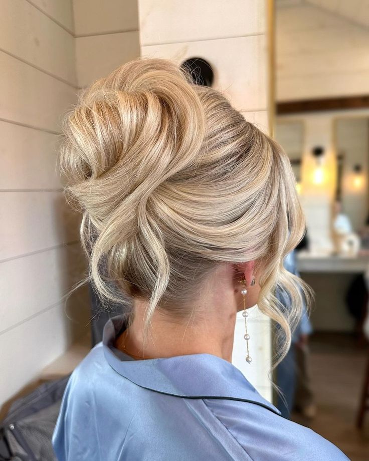 a woman with blonde hair in a low bun