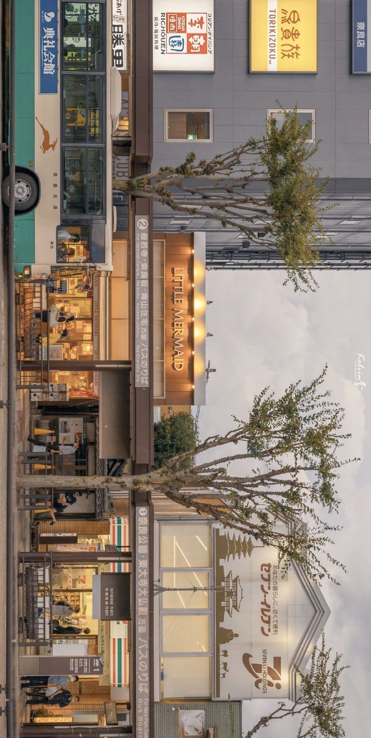 an image of a building with trees and signs on the side of it that are reflecting in the water