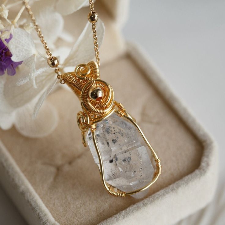 "Beautiful artisan wire design on this Herkimer Diamond crystal point. The pendant simply hung on a dainty satellite chain, finished with a spring clasp and extension. This simple and beautiful necklace is a perfect accessory for your everyday adventures and great for layering with other necklaces.  The length of necklace is approx. 18\" with 2\" extension. Because each item is handmade there may be differences from the picture viewed. Each piece is unique and no two pieces will be exactly alike Minimalist Adjustable Wire Wrapped Crystal Necklaces, Elegant Herkimer Diamond Crystal Necklaces For Gifts, Elegant Herkimer Diamond Crystal Necklace Gift, Gold Herkimer Diamond Necklace As A Gift, Gold Necklaces With Herkimer Diamond For Gift, Clear Wire Wrapped Necklace As Gift, Gold Wire Wrapped Crystal Necklace With Round Pendant, Dainty Gold Crystal Necklace Wire Wrapped, Dainty Gold Wire Wrapped Crystal Necklace