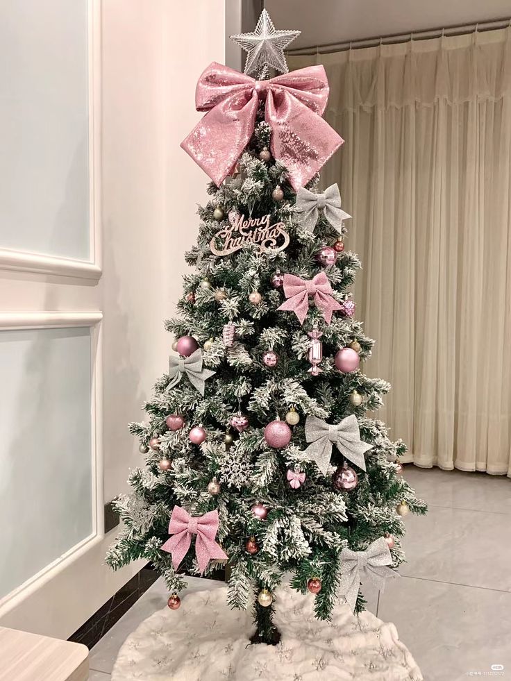 a decorated christmas tree with pink and silver ornaments