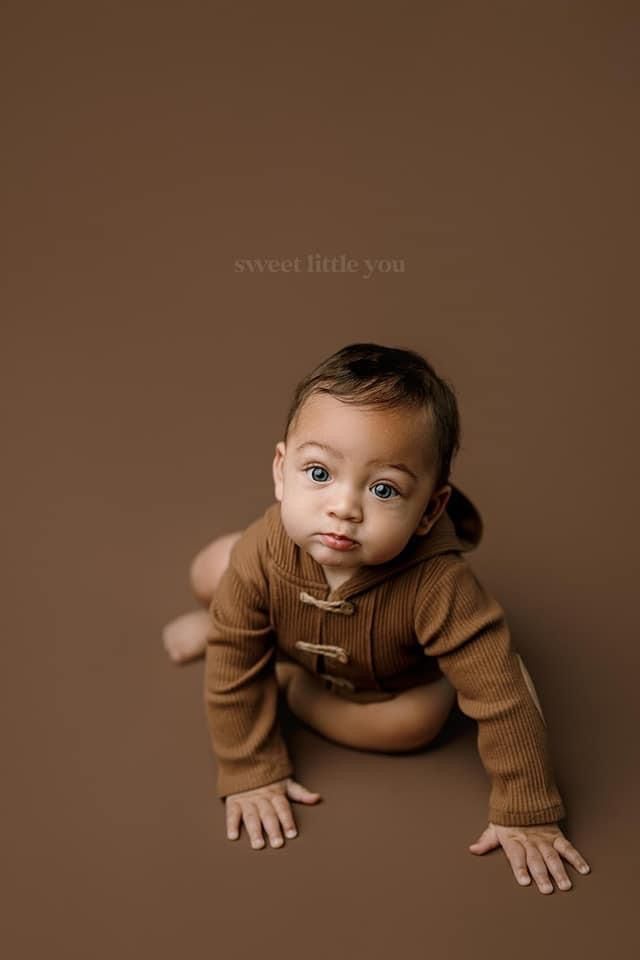 a baby is laying down on the ground