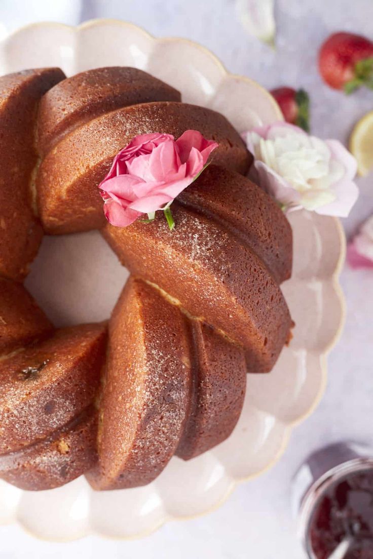 a bundt cake on a white plate with pink flowers