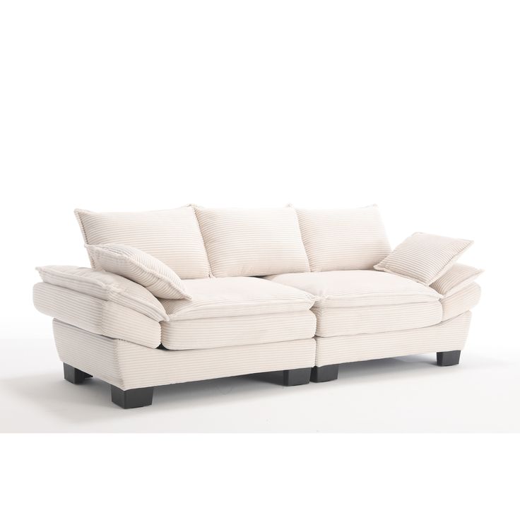 a white couch with pillows on top of it