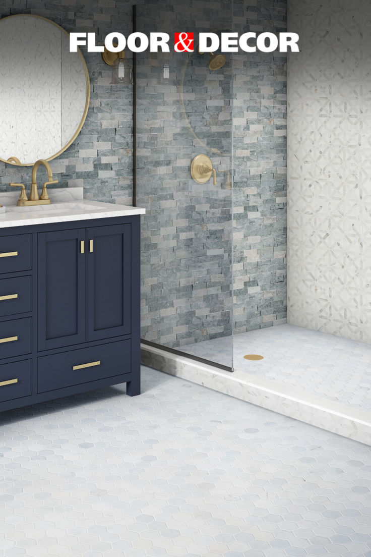 a bathroom with a sink, mirror and walk - in shower next to a tiled wall