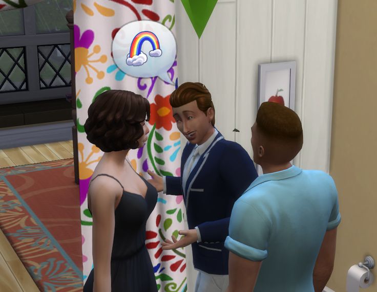 two men and a woman are talking to each other in front of a rainbow balloon