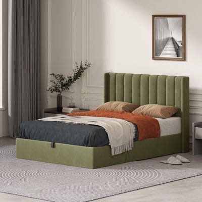 a bed with a green headboard and foot board