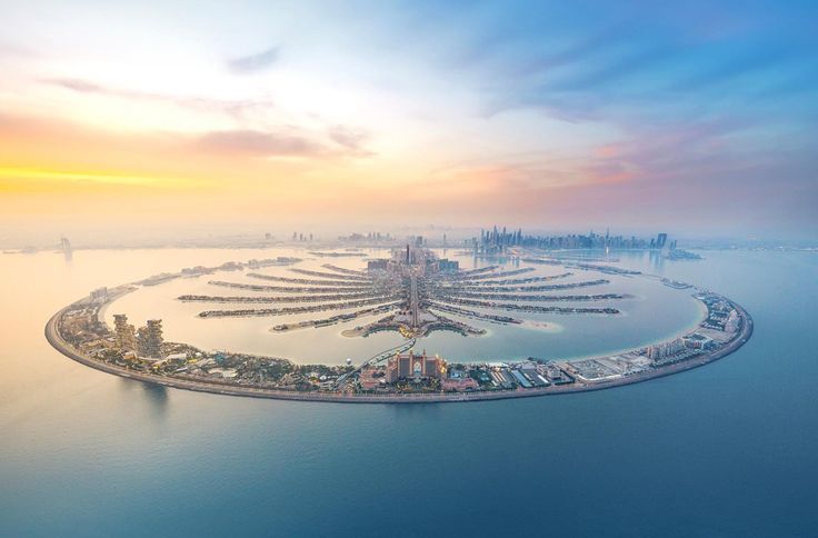 an island in the middle of water surrounded by buildings