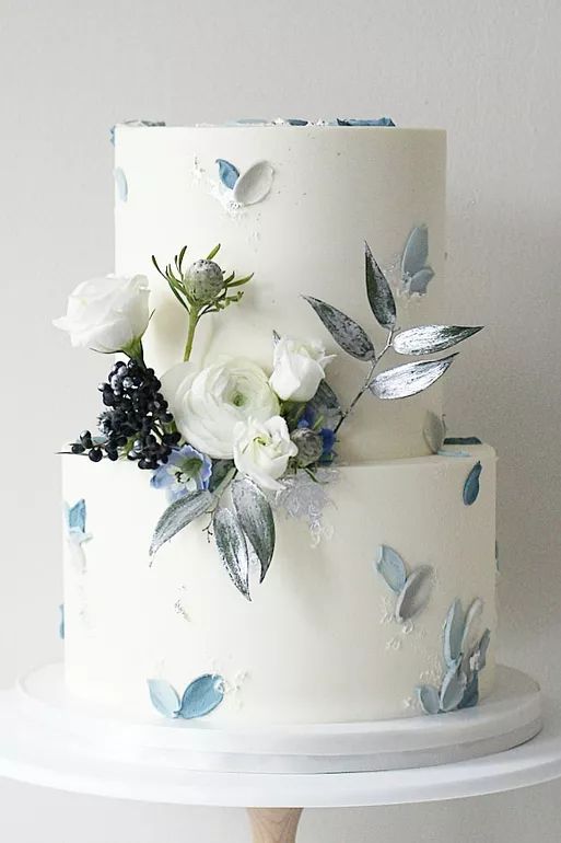 a white cake with blue and white flowers on it