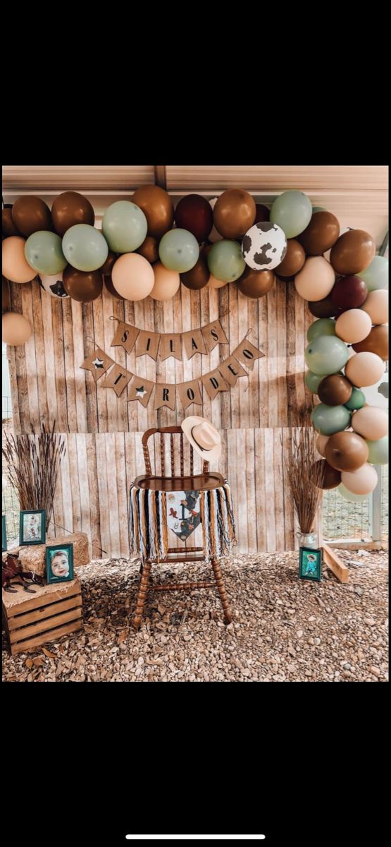 an image of a room with balloons and decorations on the wall, including a rocking chair