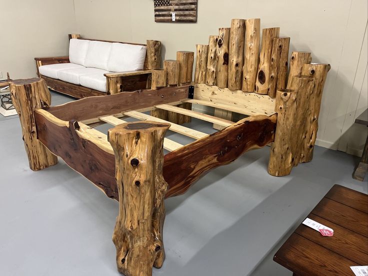 a bed frame made out of wooden logs