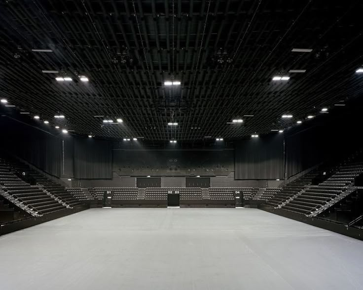 an empty auditorium with rows of seats and lights