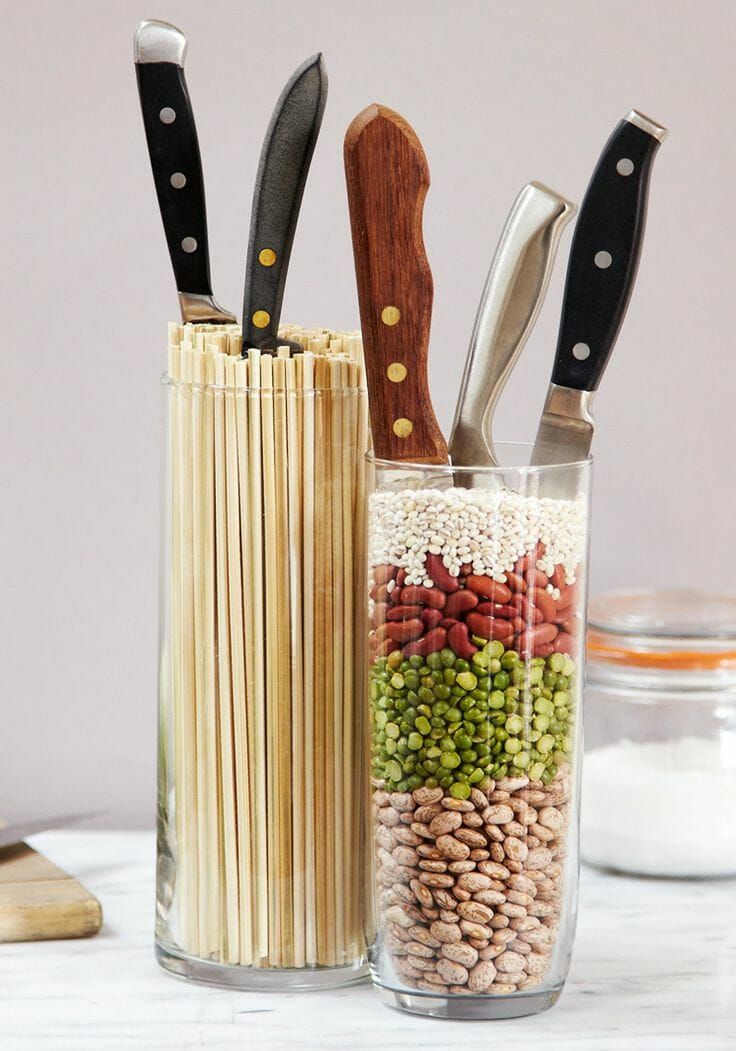 three different types of kitchen utensils in a jar with beans, peas and rice