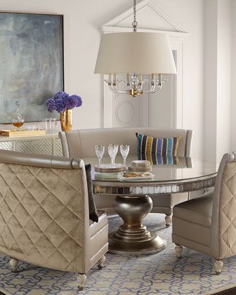 a dining room table with chairs around it and a chandelier hanging from the ceiling