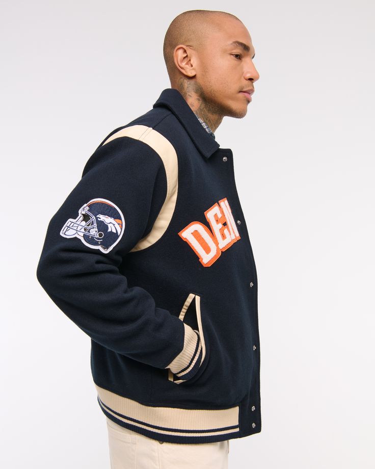 Classic bomber jacket in a soft faux wool fabric and relaxed-fit silhouette, featuring Denver Broncos varsity-inspired embroidered graphic patch details throughout, side pockets, snap-up front and tipping details at elastic cuffs and waistband. Men's Coats & Jackets, New York Jets, Denver Broncos, Wool Fabric, Mens Coats, Denver, Mens Jackets, Bomber Jacket, Relaxed Fit