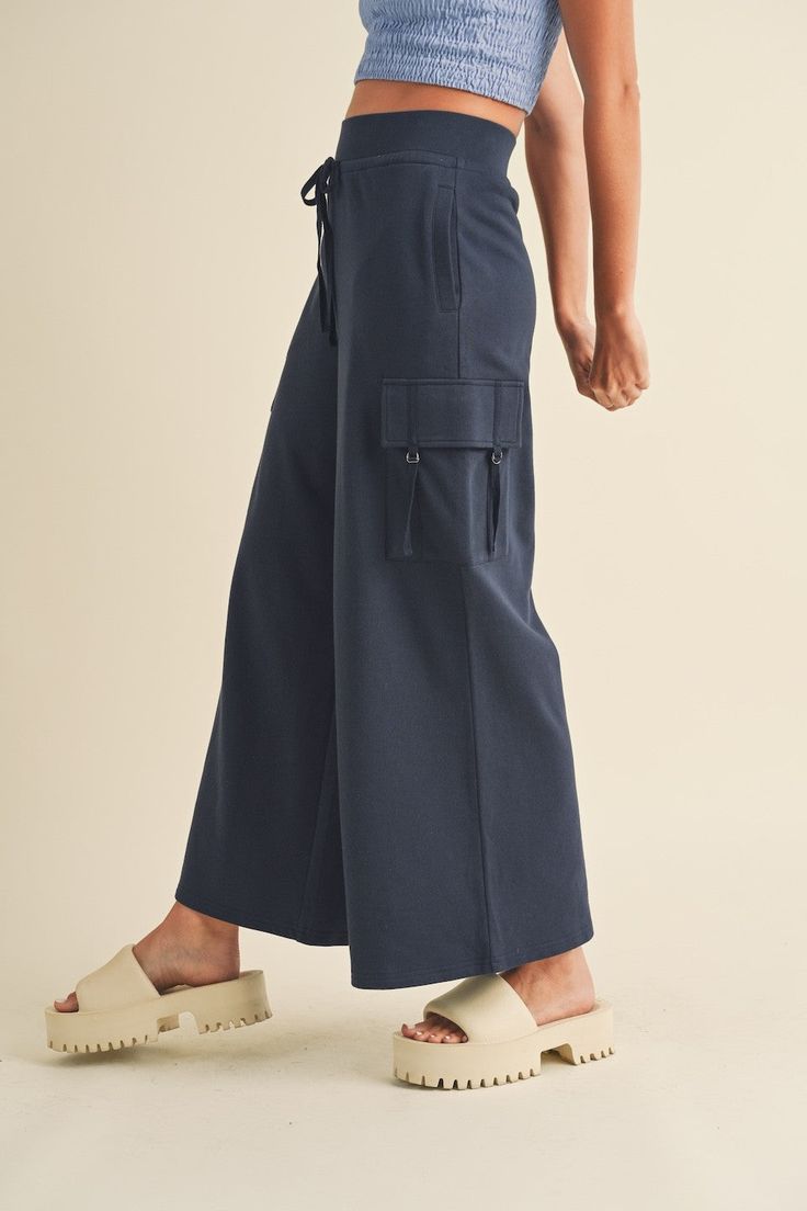 Introducing the ultimate Summer essential - our Wide Leg Cargo Pants! With a high waisted elastic waistband for comfort, adjustable drawstrings for the perfect fit, and four pockets to hold all your essentials, these pants are both stylish and practical. No more sacrificing fashion for function! Wide Leg Cargo Pants, Luxe Boutique, Boho Luxe, Summer Essential, Pants Large, Navy Pants, New Tops, Summer Essentials, Denim Dress