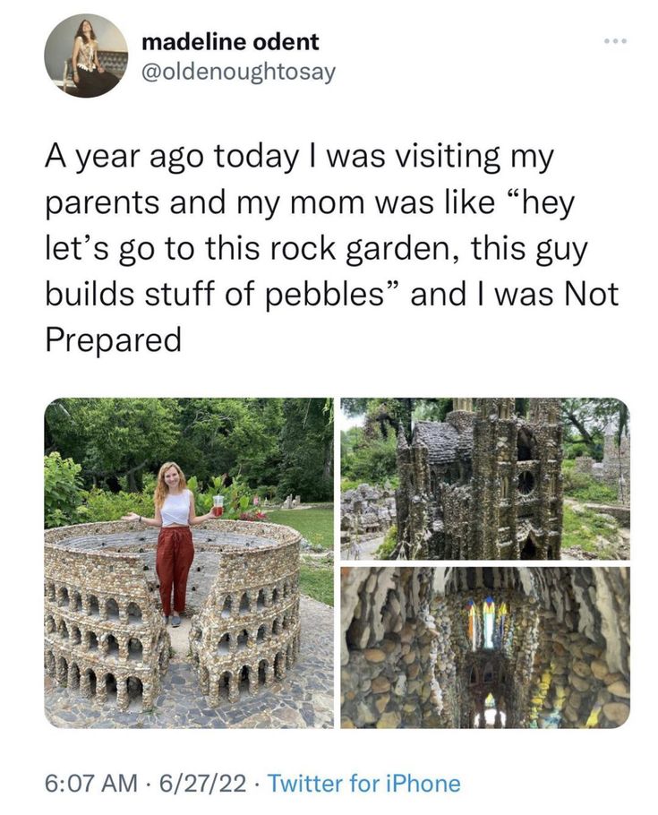 a woman standing in front of a stone structure with words written on it and pictures of the