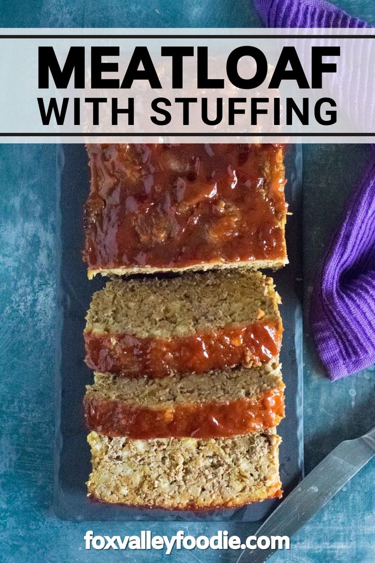 meatloaf with stuffing is cut into slices and sitting on a cutting board next to a purple towel