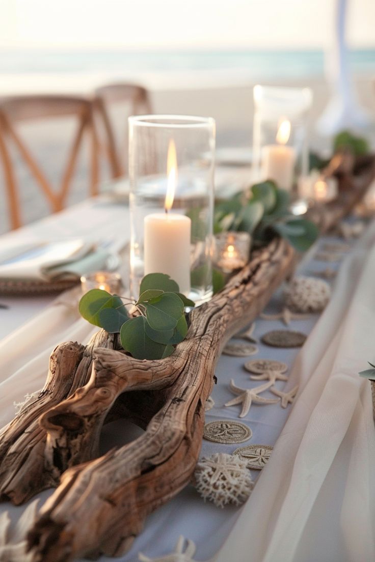 the table is set with candles and seashells for an elegant beach wedding reception