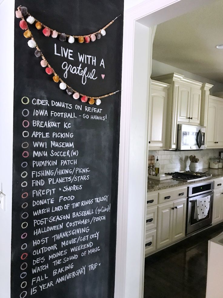 a chalkboard with the words live with a grateful written on it in front of a kitchen