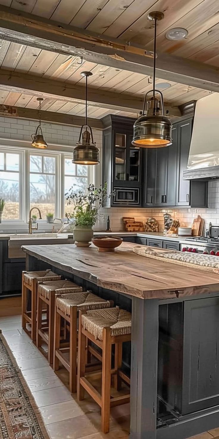 a large kitchen with an island in the middle and lots of stools around it