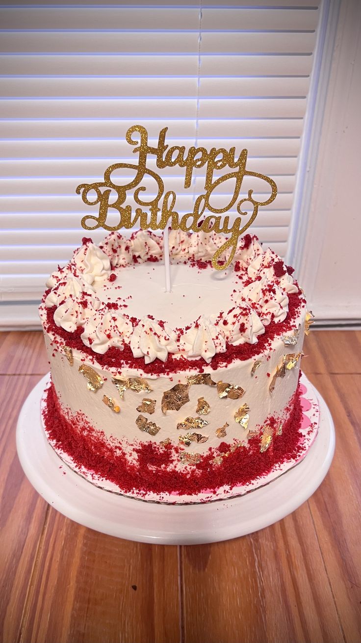 a birthday cake with red and white frosting