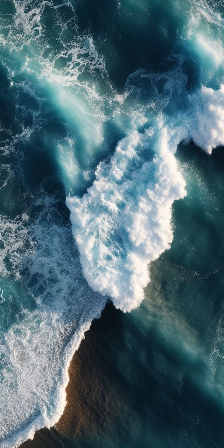 an aerial view of the ocean with waves