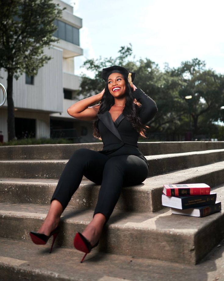 a woman sitting on some steps with her hand up to her ear and wearing high heels