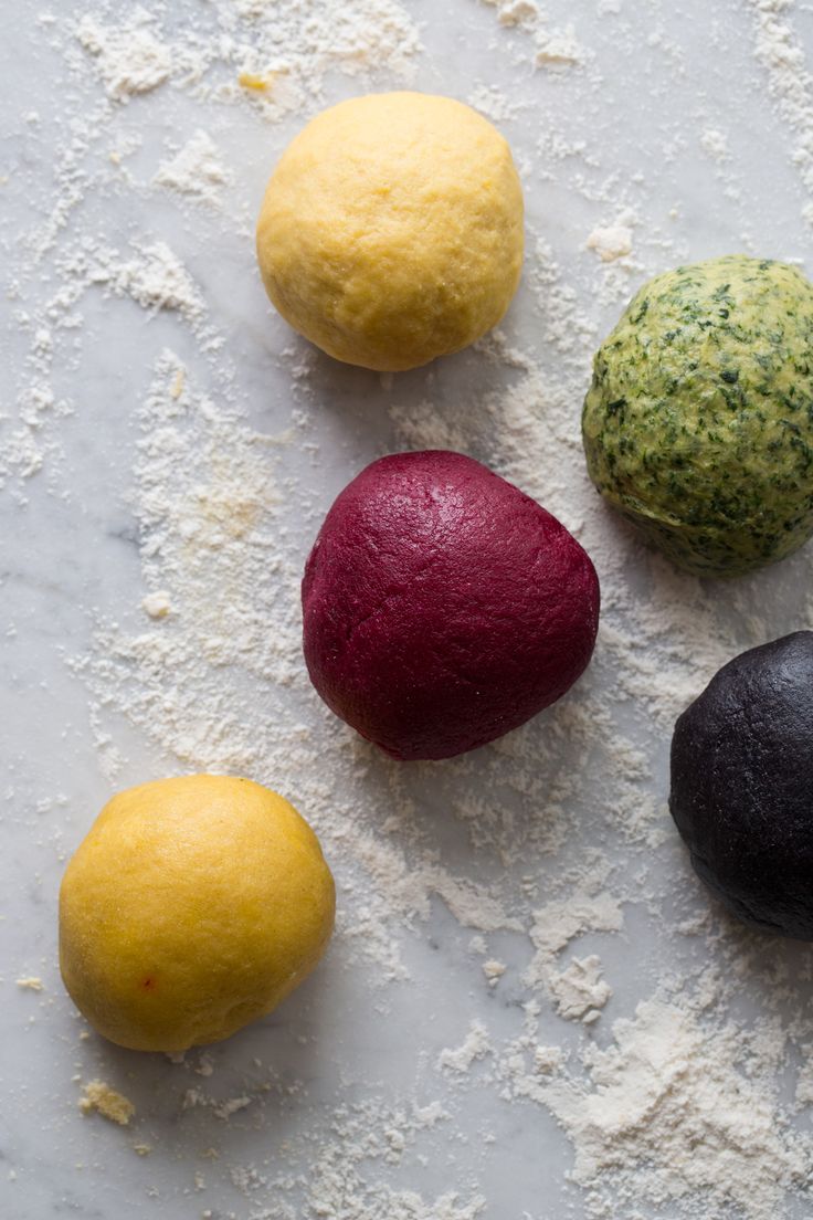 four different types of food on a white surface