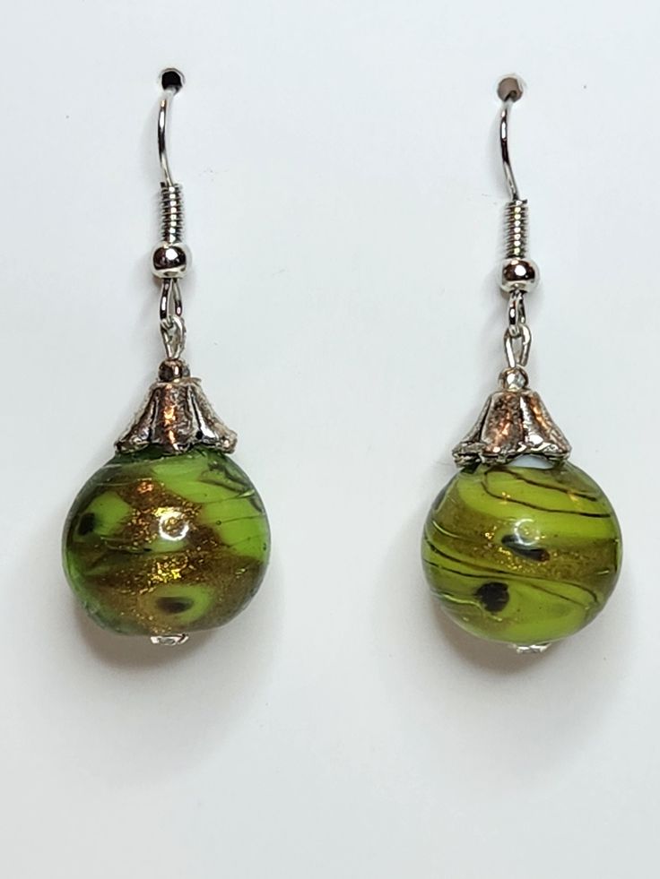 PRODUCT STYLE:     Dangle Earrings DESCRIPTION: These are beautiful green swirl glass earrings Green Teardrop Glass Jewelry, Green Glass Dangle Jewelry, Green Dangle Glass Earrings, Green Glass Dangle Earrings, Nickel-free Green Drop Earrings, Green Nickel-free Drop Earrings, Elegant Lime Green Dangle Earrings, Elegant Nickel-free Glass Earrings, Elegant Green Glass Jewelry