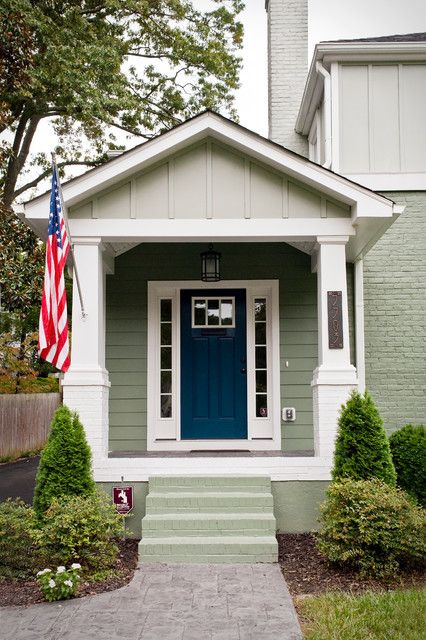 a blue front door on a gray house