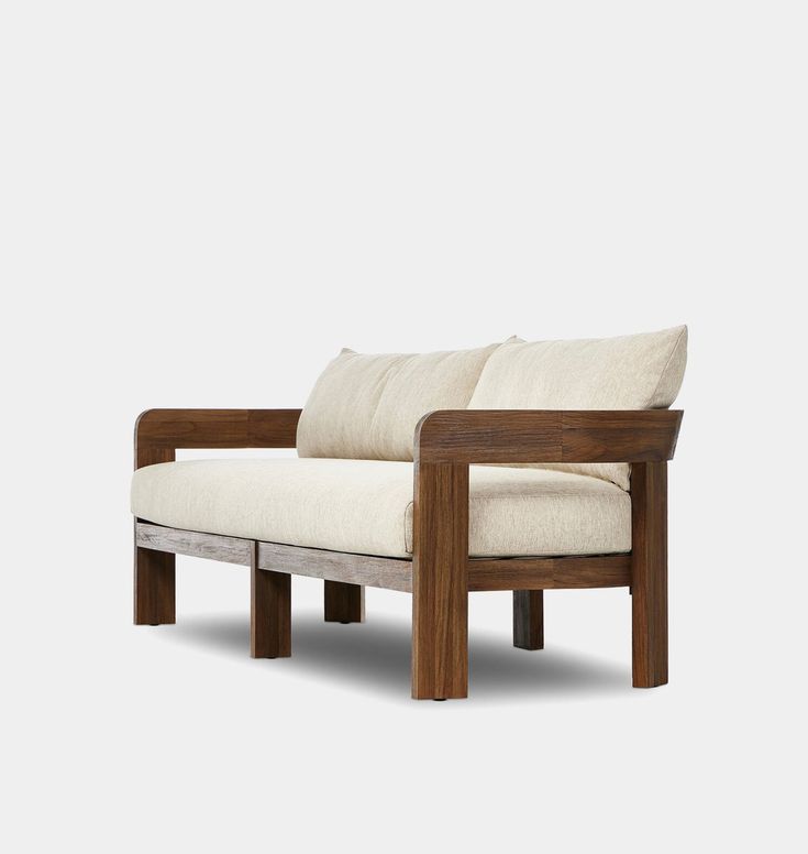 a wooden chair with two pillows on it's back and armrests, against a white background