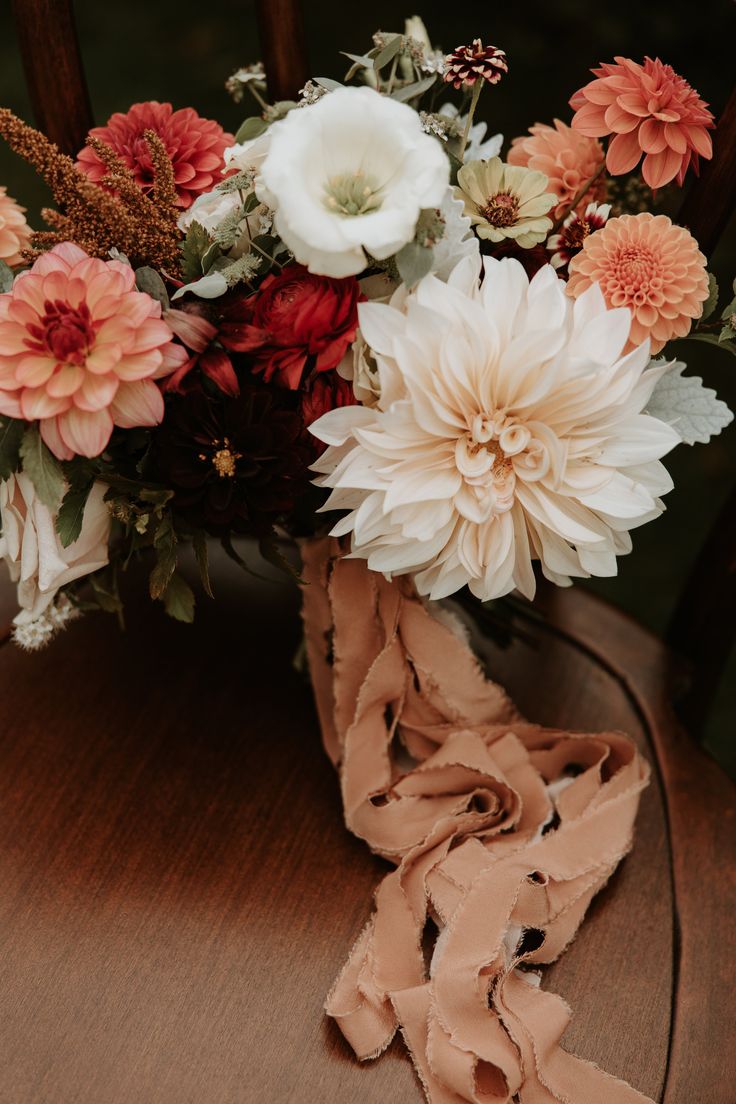 a bouquet of flowers sitting on top of a wooden table