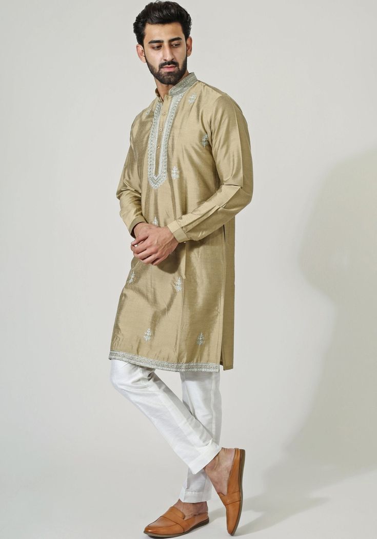 Featuring a rich gold-beige cotton silk kurta, beautifully embellished with aari embroidery. Teamed with white cotton silk pants, making it the perfect choice to shine this wedding season.Composition : Kurta and Pants - Cotton SilkCare: Dry Clean Only and Vacuum Storage This product can be customized for sleeves, length of blouse and neckline Delivery : 3-4 weeks as the product is hand crafted. Check Size Guide or choose MySize for free customisation (All Sizes above XL can be made at 15% additional cost) For more information and sizes please contact fabiliciousfashion@gmail.com or visit our Copenhagen studio. About the Designer : Chatenya Mittal started his career with a degree in Fashion from Birmingham. Since then, he has become a pivotal figure in the fashion industry and Bollywood, kn Kurta And Pants, Kurta Set For Men, Vacuum Storage, Aari Embroidery, Silk Kurta, Pants Cotton, Silk Pants, Silk Embroidery, Kurta Set