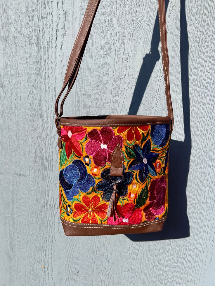 *Please advise each bag has a different design and color background. It might not be the exact flowers/ color background as the image. If you want a specific design please message us for photos* The vibrant embroidered flowers that are carefully crafted by artisans in Mexico bring beauty to this bag. You can style this as a shoulder or crossbody bag for any occasion.Measurements: 10 inches (width) x 8 1/2 (length)Made with Synthetic Faux Leather-Adjustable straps-Zipper closure pocket-Back Zippe Multicolor Floral Embroidered Tote Shoulder Bag, Multicolor Floral Embroidery Tote Shoulder Bag, Multicolor Floral Embroidered Shoulder Bag For Travel, Multicolor Floral Embroidered Tote Bag, Multicolor Floral Embroidery Shoulder Bag For Travel, Multicolor Floral Embroidered Shoulder Bag, Multicolor Floral Embroidered Daily Bags, Multicolor Embroidered Everyday Bags, Multicolor Floral Embroidery Bags For Daily Use