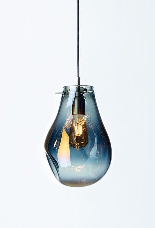 a blue glass light bulb hanging from a wire